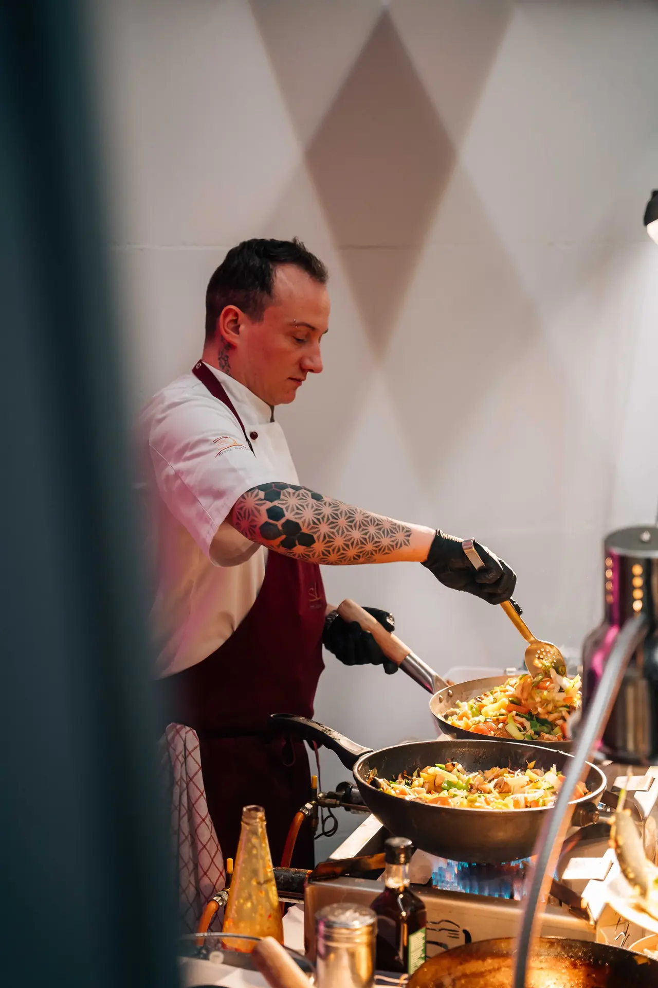 Koch richtet Speisen direkt an der Live-Cooking-Station an